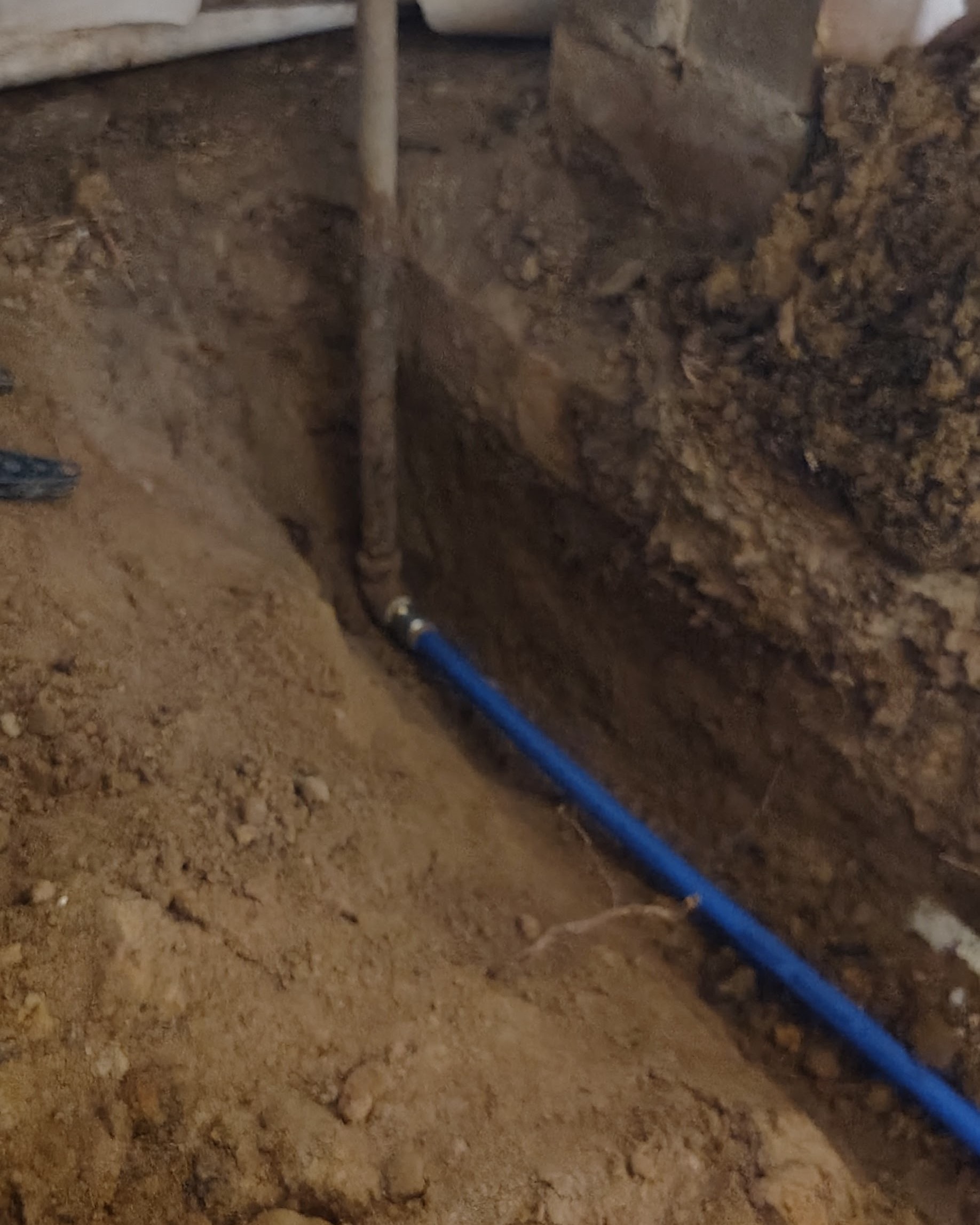 Installation of underground plumbing line.